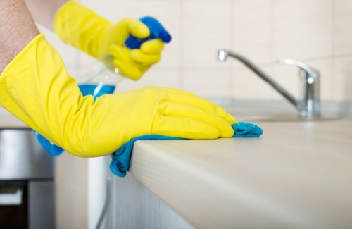 Cleaner in Uxbridge performing detailed cleaning in a well-kept room